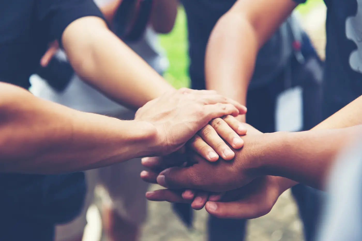 Team members joining hands